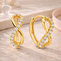Goldene Creolen Ohrringe aus 585er Gold für Damen im Infinity-Design mit funkelndem Zirkonia-Besatz.